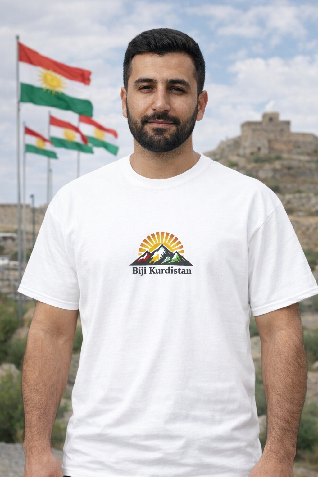 White t-shirt with mountains and rising sun graphic featuring the text “Bijî Kurdistan”