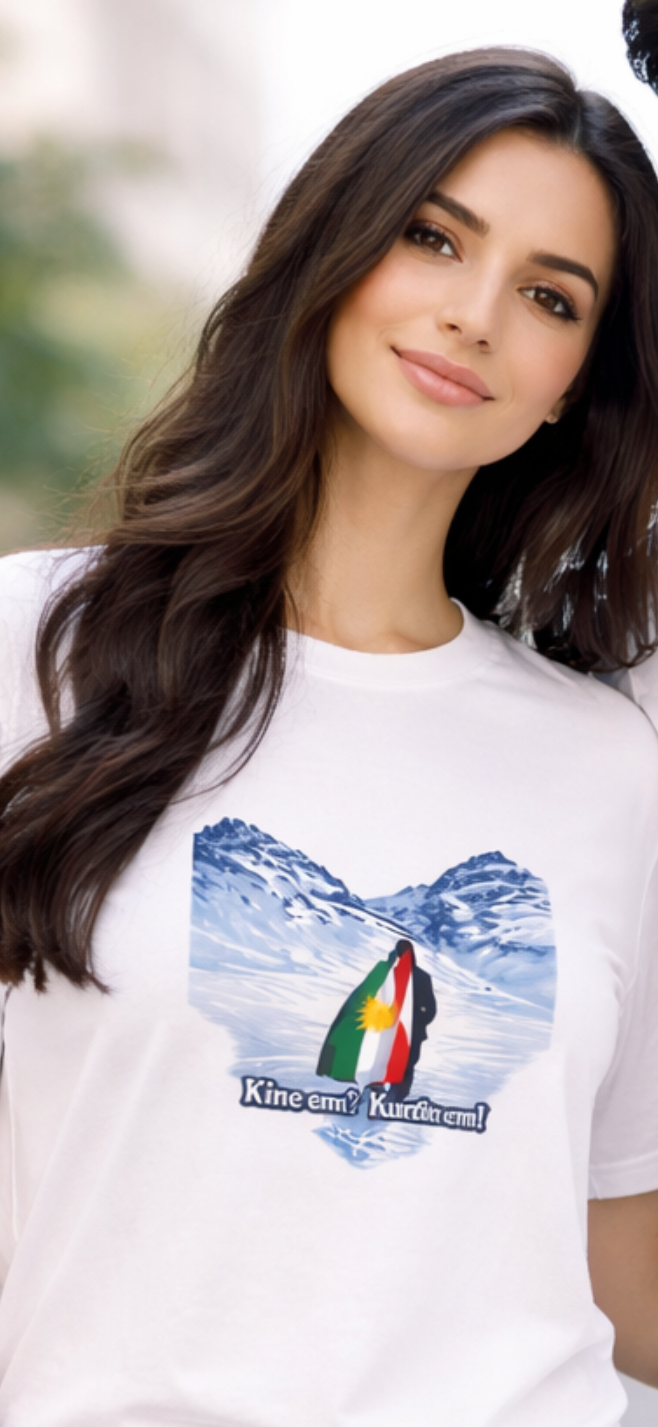 White t-shirt with snowy mountain landscape and Kurdish flag featuring the text “Kînem? Kurdim!”